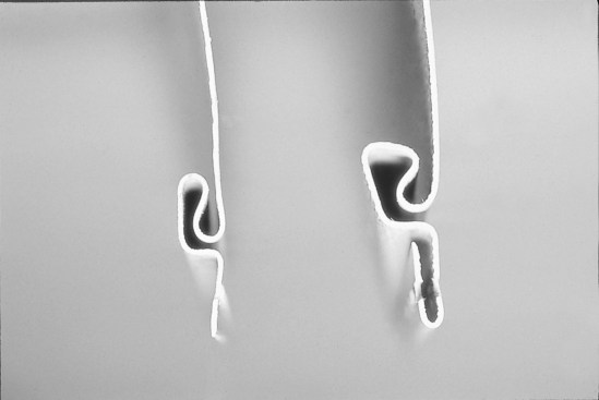 A double-thickness nail hem like the one on the left is less likely to rip in a windstorm.