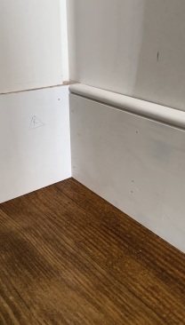 The trimmed baseboard meets the plinth block as intended with a clean line at the floor.