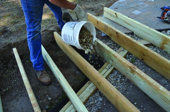 Crushed stone was placed around the beam to provide drainage.