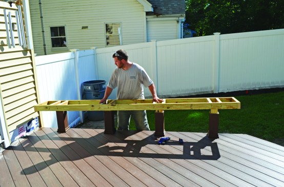 A ladder-framed bench structure was fastened to the post ends.