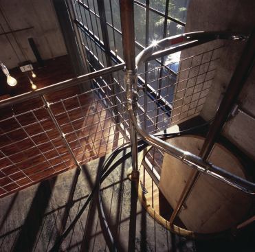 A refurbished pole—which predates the steel-mesh safety gate—provides the owner of this artist’s studio with a direct route downstairs.  