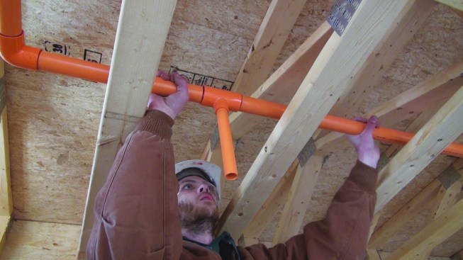 He jams the pipe into the fitting until the pipe bottoms out against the fitting.