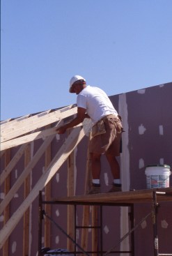 Then the crew sets trusses for the roof.