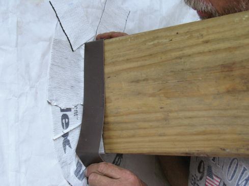 A 1 1/2-inch-wide strip of aluminum coil stock protects the tape and creates a crisp line for siding and trim to butt against.