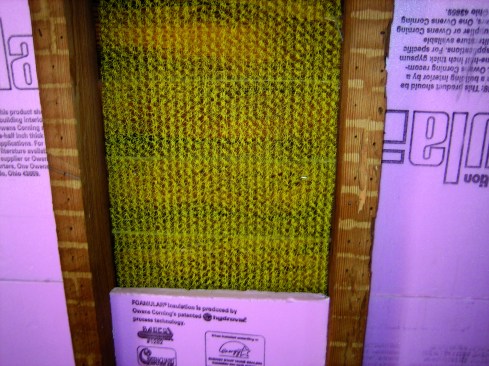 Consultant Paul LaGrange opted to place open-weave drain fabric against the wall, set rigid polystyrene insulation board against the drainage material.