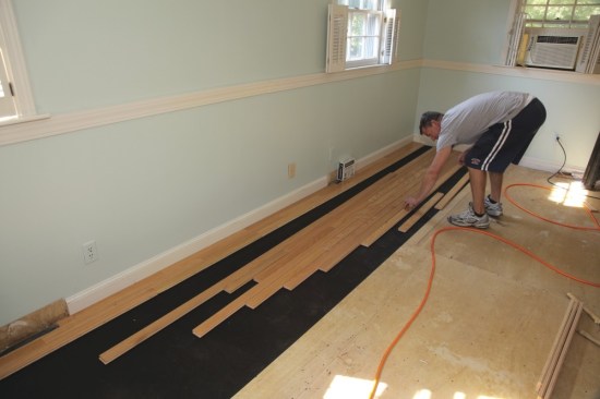 In theory, the small dimensional change across the width of one flooring board can add up to a large change across the entire floor. For this reason, it is recommended that unfinished hardwood strip flooring have a gap of 1/2 to 3/4 inch at the edges. In practice, thick hardwood flooring tends not to move a whole lot if it is nailed off adequately (every 4 to 6 inches is not too much for strip flooring), and if it is installed near equilibrium moisture content and indoor climate conditions are maintained.