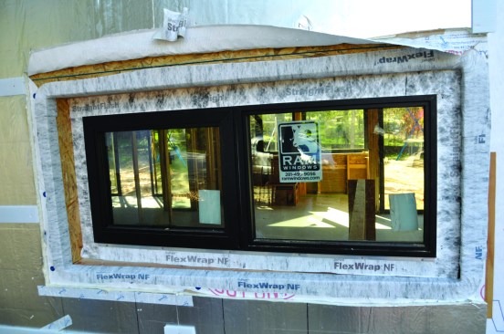 To remedy the botched window job on his site, the author worked with the local Tyvek distributor. The housewrap was peeled back and FlexWrap applied along the edges of the recessed opening and over the window flanges.