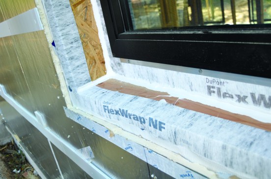 Next, Tyvek Flashing and Joint Compound is gun-applied into the corners.