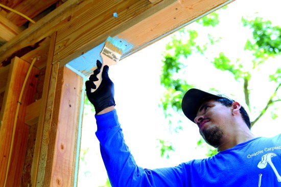 Using the Polyguard Blue Barrier system on one window, a carpenter first applied the thicker of two flashing compounds—Joint Filler 2200—into the corners and to fill the gap between the exterior sheathing and the framing. He then brushed on the thinner, Flash ’N Wrap 2400.
