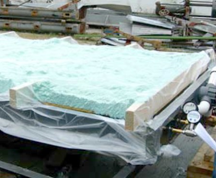 A test panel (left) in a study at the University of Florida simulates a roof assembly consisting of 1/2-inch OSB fastened to 2x4 framing at 24-inch centers. The framing bays have been filled with closed-cell spray foam.