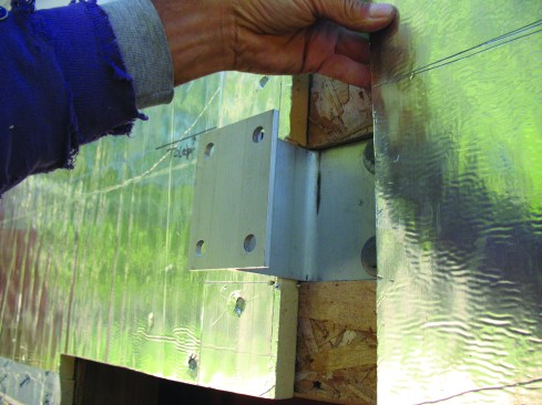 The foam panel is cut to fit around the bracket web. The brackets can accommodate foam up to 3 inches thick.