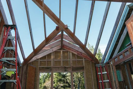 At the intersection of the valleys and the minor ridge, we ran 5/8-inch threaded rod and used bearing plates to spread the load over 6-by blocks cut at 45 degrees.