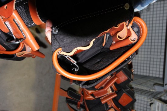 The "fat lip" stiffens the edge of the pouch and holds it open for better access. It is created by wrapping a piece of rope in leather and then stitching it onto the edge. Note the leather tool holders and plastic chisel sheath inside.