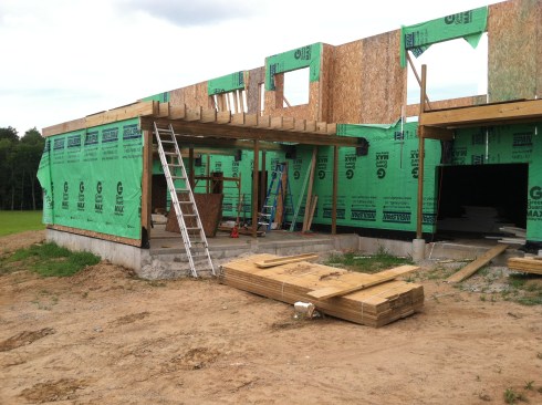 The beams are pitched 1â4 inch per foot for drainage, and support the roof deckâs 2x10 framing.
