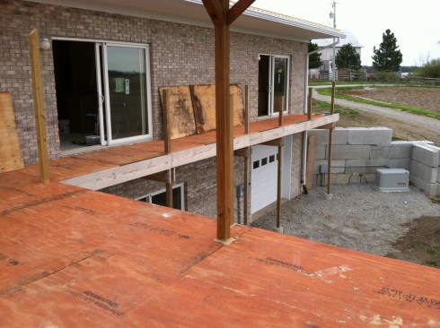 The author applied adhesive to the joists before fastening the 3/4-inch T&G plywood to the deck framing with screws.