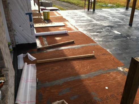 The author then applied the waterproofing to the main roof deck, working in roughly 3-foot-wide sections to correspond to the width of the polyester reinforcing fabric, which comes in 1-meter-wide rolls.