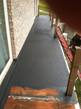 The fabric was laid out over a wet coating, then embedded into additional coating with either a roller or a trowel. It took several coats to build up to the 30-mil thickness recommended by the manufacturer.
