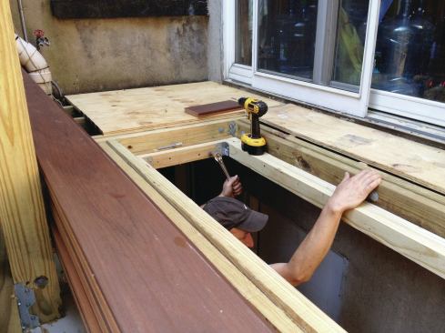 To support the skylight, workers glued, nailed, and bolted a 3-inch-wide ledge to the rough opening. Plywood was used as temporary decking during construction.