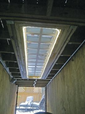 When the skylight is covered with snow, an LED rope light helps brighten the area under the deck. In warmer weather, the illuminated skylight adds a unique decorative accent to the deck.