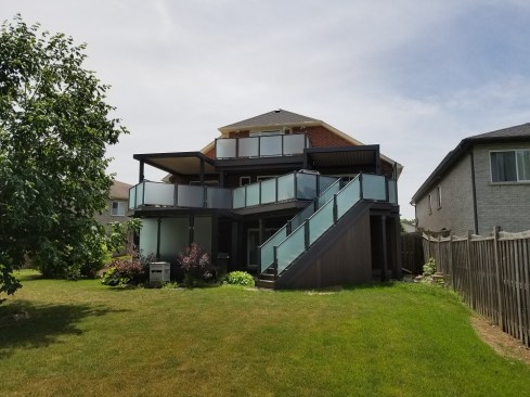 Opening things Up; I suggested adding 2 doors and an upper level deck. Our client is an accountant and her office is on the 3rd floor of the home. Adding a door with a small deck enables her to take her work outside on beautiful sunny days. People invest in a dream deck to enjoy  life. Another door was opened up to the master bedroom on the main deck. 
Glass 3 season room;  Beneath the smaller louvered roof on the main deck, glass walls will be added soon to create a very unique 3 season room. 
