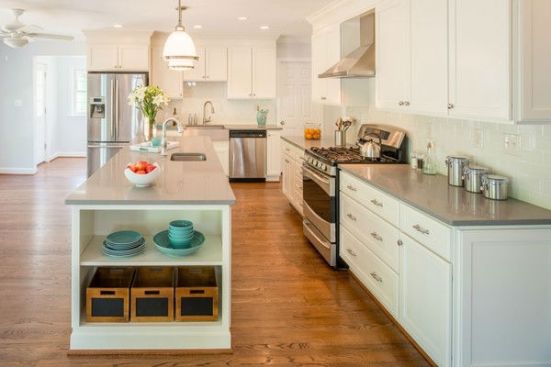 A light, clean and simple color palette sets the tone for the new kitchen  that features plentiful cabinetry and counter space, as well as a walk-in pantry and a breakfast area. 