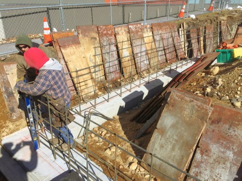 Crew members tie rebar.