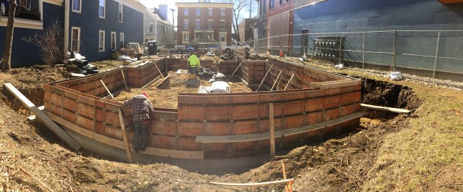 This iPhone panorama photo of the site gives an idea of the lot dimensions. Tight setbacks and a deep lot add some wrinkles to the construction problem.