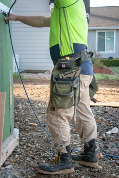 The tape-measure pouch holds a 35-footer nicely. Good for what I do: framing. There’s also a sleeve for a nail puller.