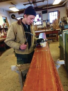 Bolt holes in recycled bleacher boards are carefully filled with matching plugs.