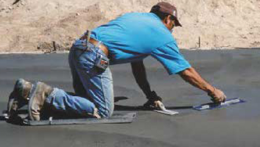 Even with a power trowel on the job, some hand-finishing is necessary around obstructions.