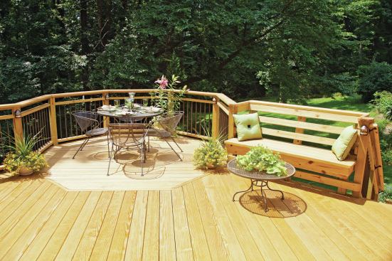 These posts and rails are made of treated southern yellow pine, while the balusters are aluminum. Note the post-mounted built-in deck lighting, a great upgrade for dining after dark. 