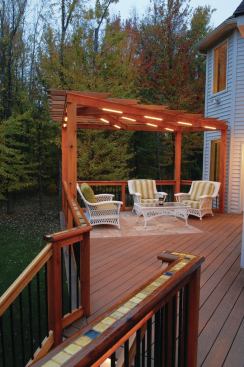 The tile inlay in this cedar rail was installed using offcuts from the deck's travertine tile sitting area (shown in the background), mixed in with pieces from other tile projects.
