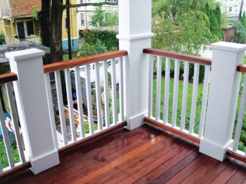 In this railing design, the upper and lower rails were milled to match the mahogany decking. The balusters are painted fir, and attached with screws and nails to PVC subrails.