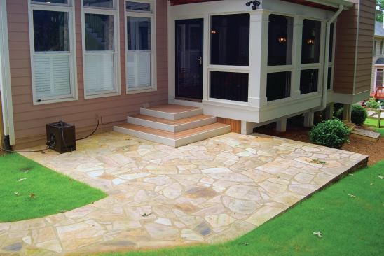 On a level site where the interior floor is close to grade, a patio is often a better and less-costly option than a low-elevation deck.