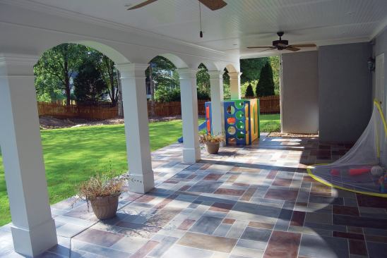 When a concrete slab has been extended, a thin concrete coating can be used to visually tie the old and new slabs together. The coating shown here has been stamped and colored to look like natural stone. 