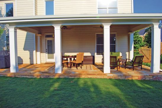 When a porch or overhead structure is involved, the author elevates the patio’s outer edge 4 to 8 inches above the ground, with enough slope to shed water. This minimizes ground splatter from rain, keeps lawn-mower wheels from rolling across the patio and tracking it up, and provides a defined edge for a weed whacker. 
