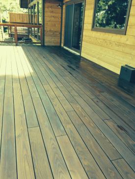 While heat-treated wood quickly turns gray, it can be 

pressure-washed and re-treated to restore color. This deck was restored after a year in the sun.