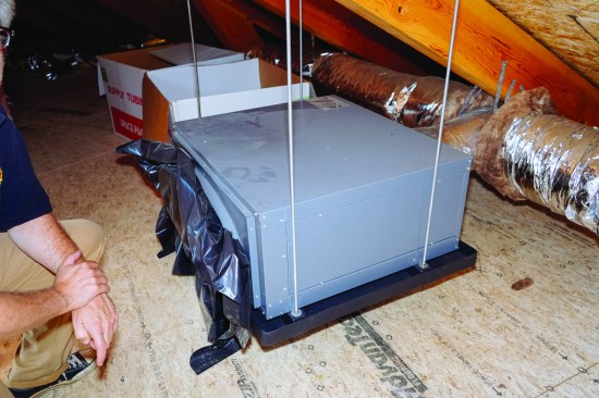 On the second floor of this home, a SpacePak high-velocity hydro-air unit will supply heated or cooled air using fluid supplied by the same outdoor-mounted heat pump.