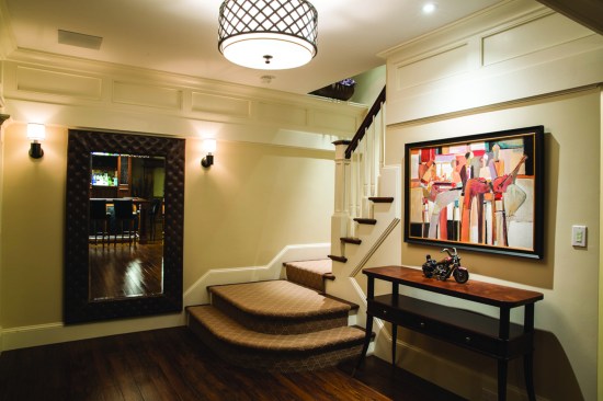 Sergio Mazon’s custom lighting design specified LED luminaires for the basement living space, including a ceiling pendant, wall sconces, and accent lighting for art work in the entry.