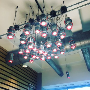 Hilti handed an electricical contractor dozens of its fire-stop sleeves used for floor penetrations and said "make us lights using these". This is what the contractor came up with. There are several of these "fire-stop chandeliers" throughout the company's office space. 