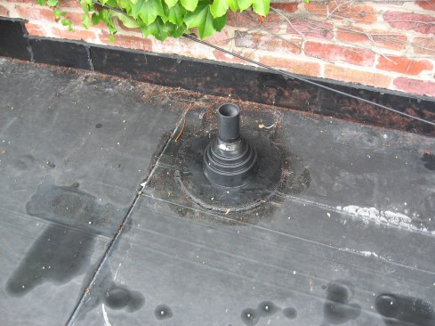 A factory EPDM collar for this plumbing vent is more reliable than a site-made flashing. 