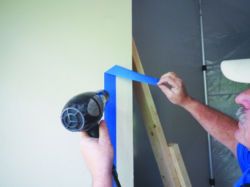 Plastic should be taped to walls and ceilings, but stay away from finishes that could be damaged when you are removing the tape. A hair dryer can soften adhesive to help prevent damage when tape is removed.