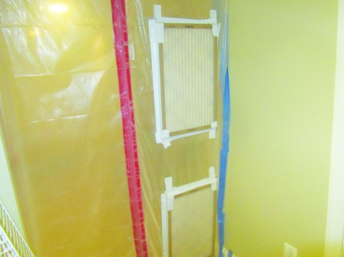 Tape furnace filters to holes in the plastic to control dust while relieving air pressure from wind.