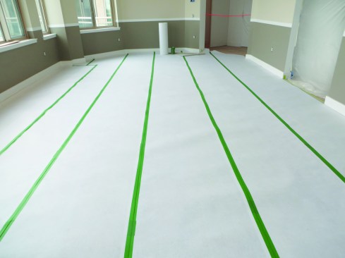For protecting wood floors, he advises starting with a base layer of tacky felt.