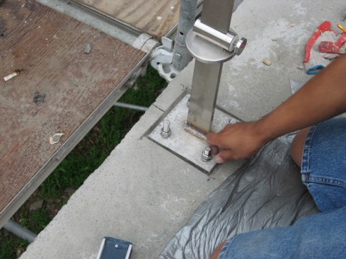 Next, the metal-post base plate is connected to
the bolts.