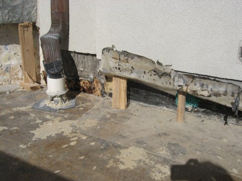 The joint where the rubber roofing met the masonry was seen to be compromised, and aluminum flashing behind the block was corroded and leaky.