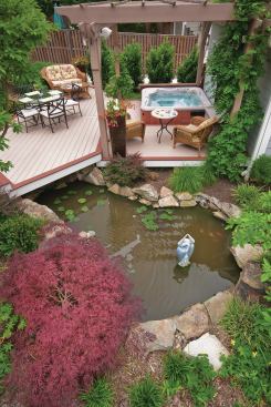 This hot tub is on the lowest level of a three-level deck, complete with a sound system and lighting. A small pond and landscaping soften the area.