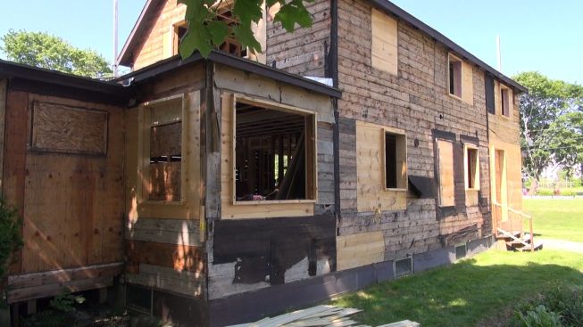 The original board sheathing remains in place, except where new window openings have been framed. The plan is to cover the exterior with Dow Styrofoam, taped at the seams, to form a new insulated air control layer and drainage plane.