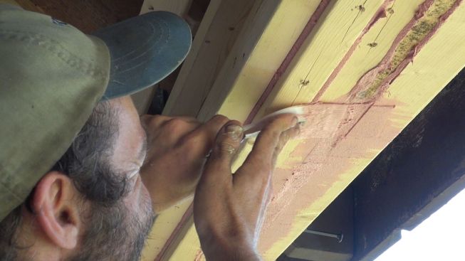 Kelly tools the waterproof, vapor-open Joint and Seam Filler with a plastic trowel. The goal is to provide a reasonably smooth base for Prosoco 