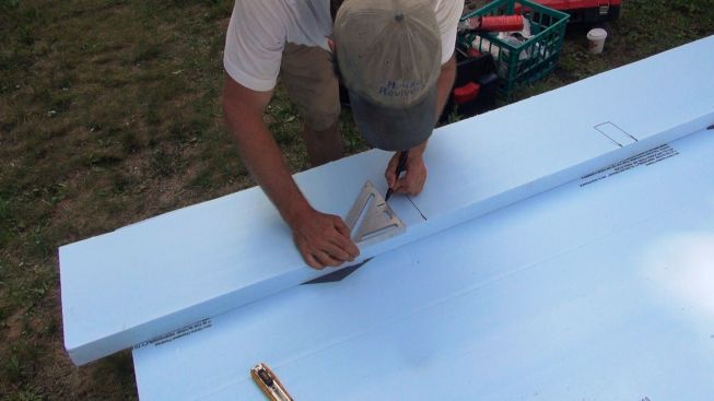 Kelly makes layout marks for cutting the piece of XPS foam.